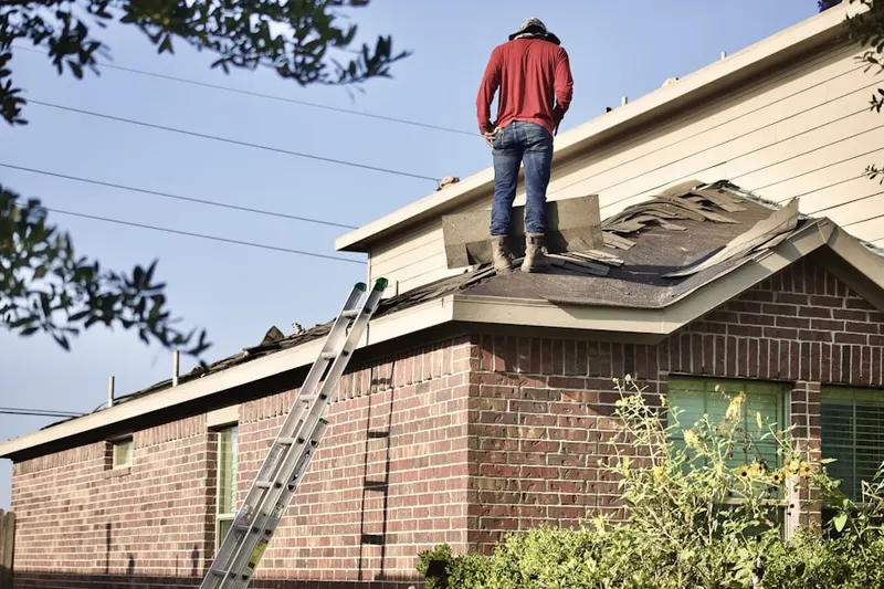Professional roofer working on a residential roof in Buckner Terrace